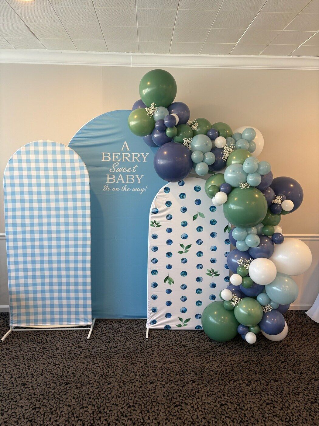 Blue gingham baby shower arch backdrops with a balloon garland