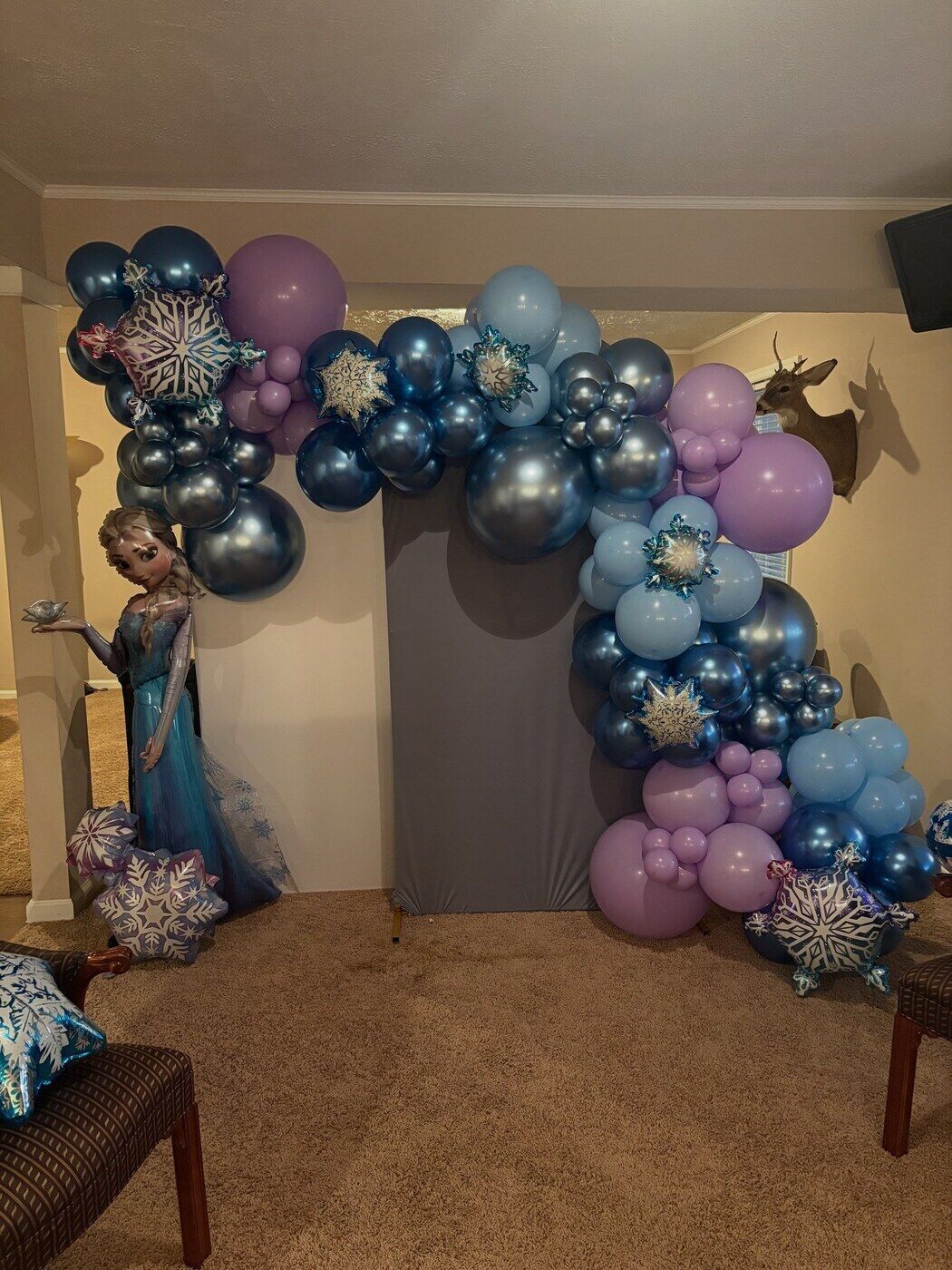 Blue and silver winter themed balloon arch with snowflake foils