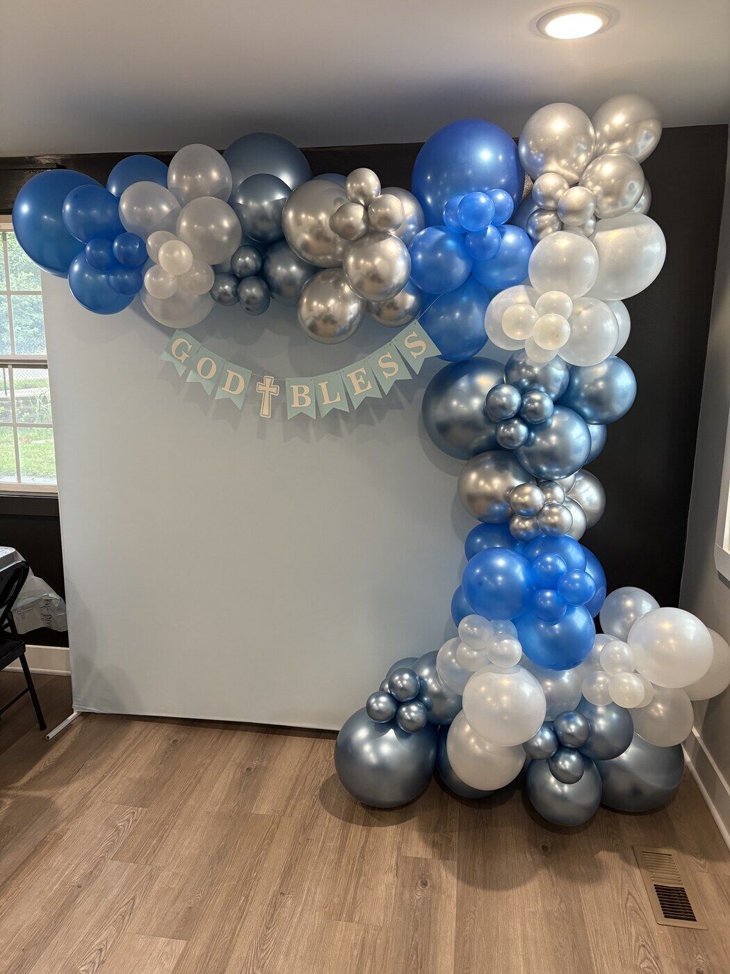 Blue, silver and white balloon arch for a baptism, with a God Bless banner