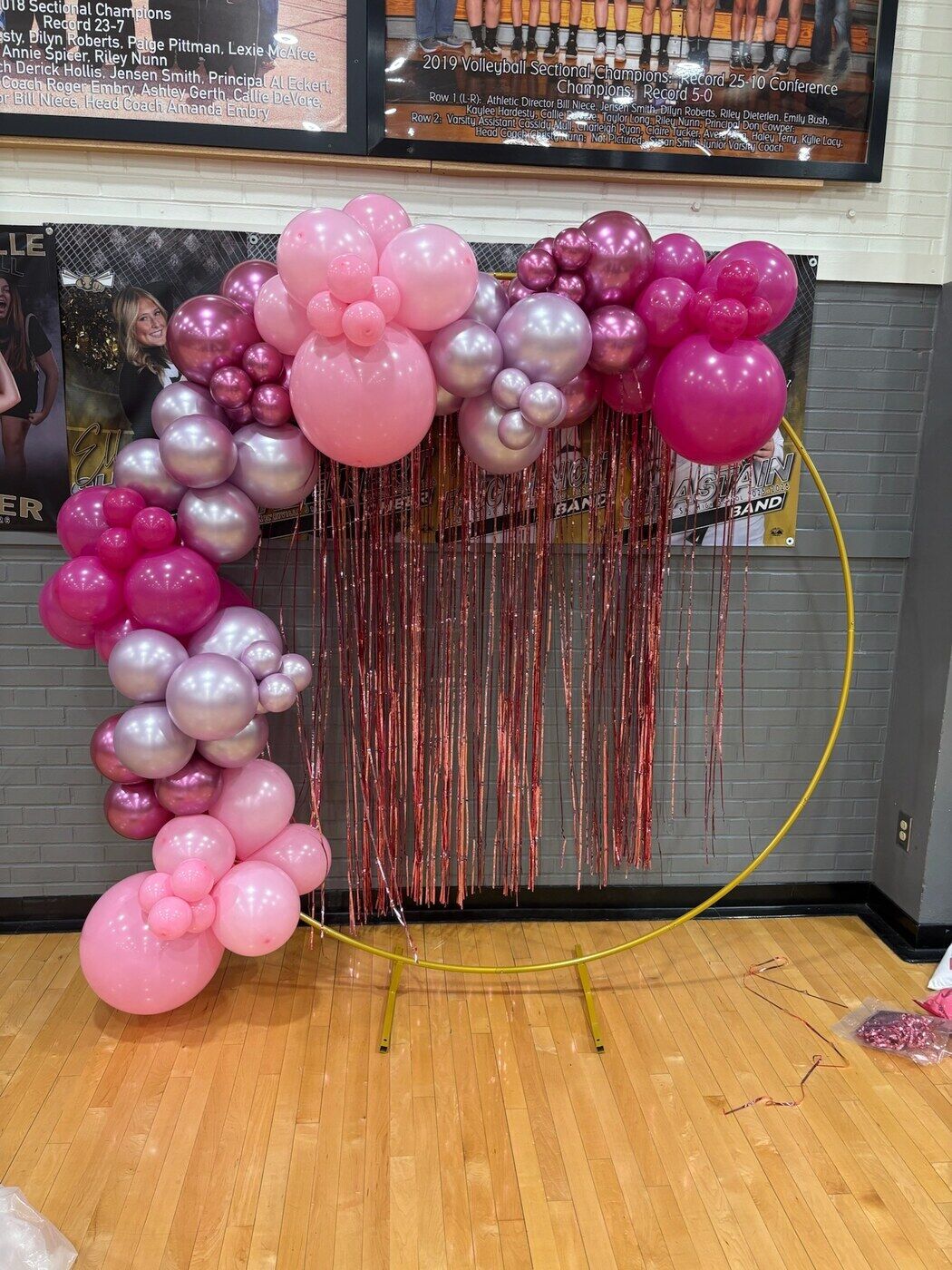 Hot pink and rose gold balloon garland on a gold hoop with fringe
