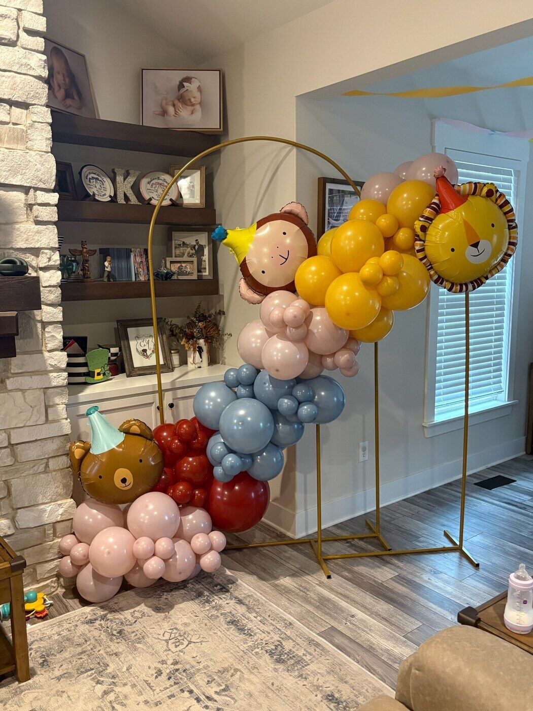 Gold and blue balloon garland on a hoop with a sun face balloon