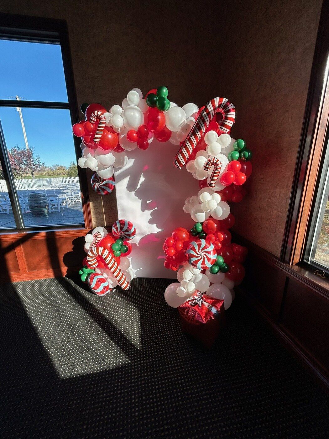 Red, white and green candy cane balloon arch for Christmas