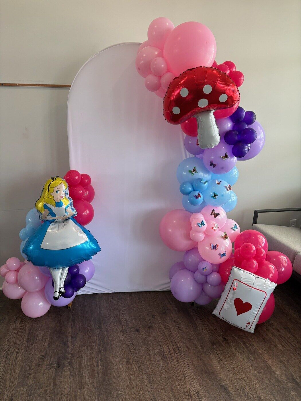 Alice in Wonderland balloon display with mushroom and character balloons