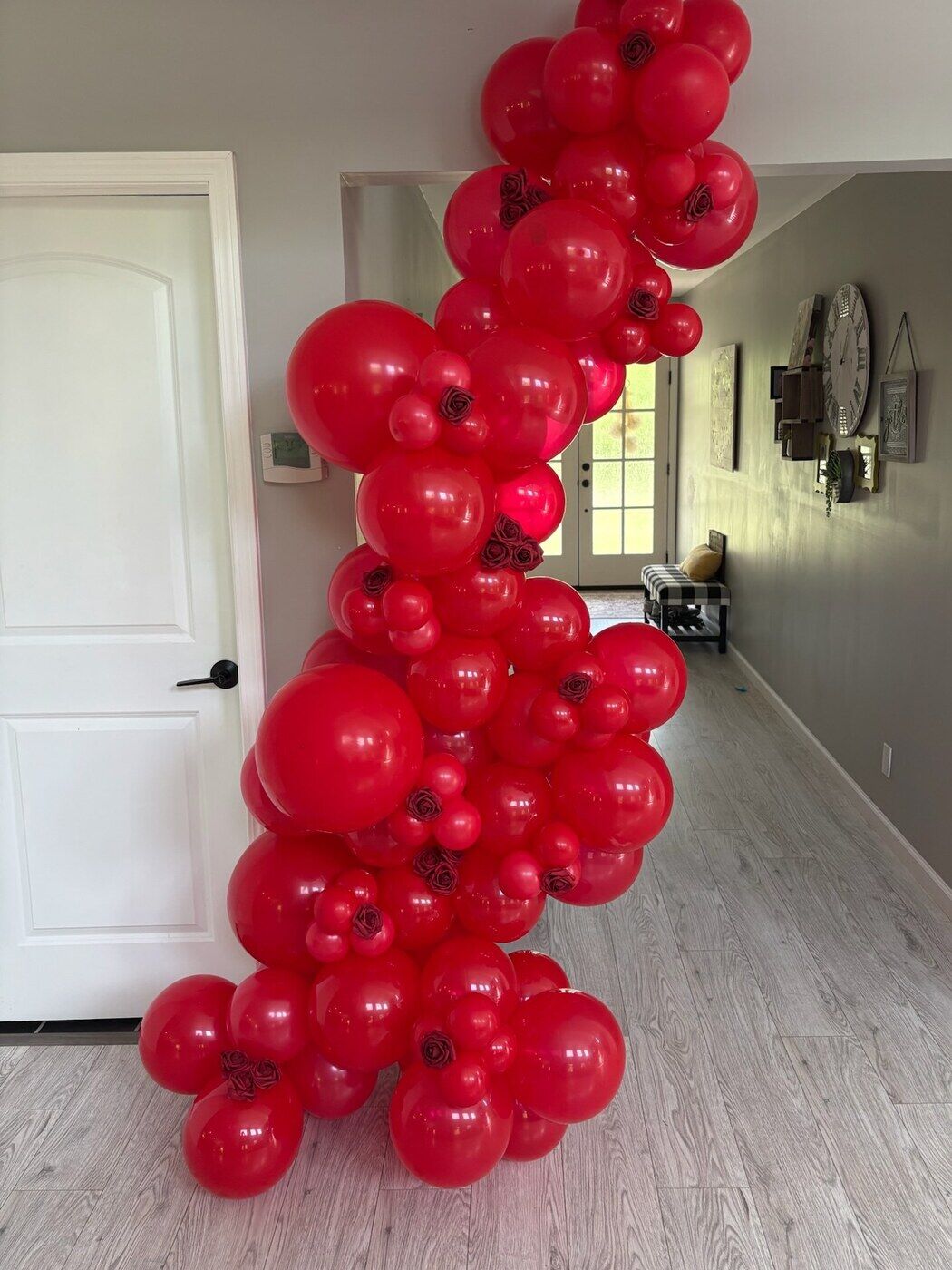 Deep red balloon column beside a doorway